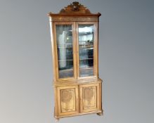 A 19th century continental burr walnut and ebonized double door bookcase fitted with cupboards