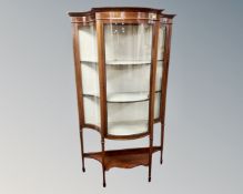 An Edwardian inlaid mahogany bow front glazed display cabinet.