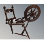 A miniature antique spinning wheel.