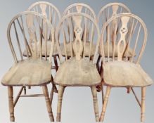A set of eight oak wheelback dining chairs.