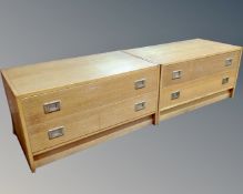 A pair of oak effect two drawer low chests.