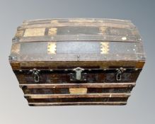 An Edwardian canvas, wooden and brass bound travelling trunk.