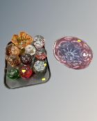 A tray of glass paperweights,