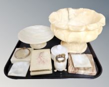 A tray of alabaster and onyx ornaments including pedestal fruit bowl, table lighter,
