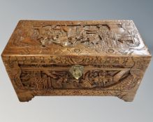 A heavily carved camphor wood blanket box,
