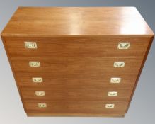 A 20th century teak veneered chest of five drawers.