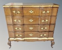 A 19th century serpentine front oak and parcel gilt four drawer chest raised on cabriole legs.