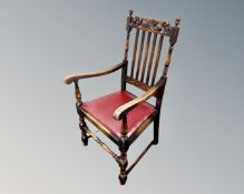 An Edwardian oak hall chair together with a further 19th century carved and stained oak hall chair.