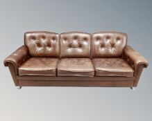 A 20th century Scandinavian brown buttoned leather upholstered three seater settee, length 198 cm.