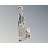 A Lladro figure of a woman and geese.