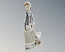 A Lladro figure of a woman and geese.