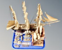 A tray containing wooden model ships, a pair of ship bookends, ship in bottle.