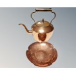 A brass and copper kettle together with a copper flower head dish