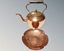 A brass and copper kettle together with a copper flower head dish