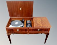 A reproduction mahogany effect radiogram containing Garrard SP25 mark IV turntable and Dynatron