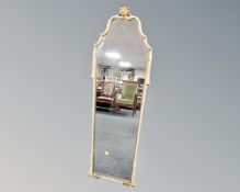 A continental cream and gilt tasselled frame mirror.