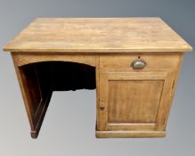 An Edwardian oak single pedestal writing desk.
