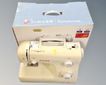 A Singer Symphonie electric sewing machine in box with lead and foot pedal.