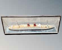 A scale model of the Mauritania in triangular glazed display case,