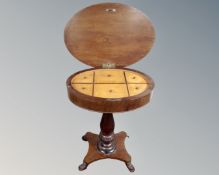 A 19th century continental mahogany sewing table on quatrefoil lion's paw base.