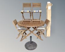 A John Lewis Capri circular garden table and parasol together with a set of four folding chairs