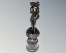 A bronze figure of a nude female standing in a clam shell, on marble socle,
