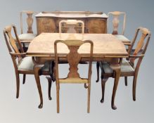 An eight piece walnut Queen Anne style dining room suite comprising of serpentine fronted sideboard,