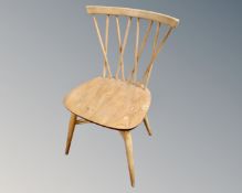 An Ercol solid elm and beech cross spindle backed dining chair.