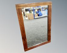 An Edwardian oak framed mirror.