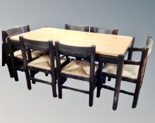 A 1970's two-tone dining table together with a set of six rush seated chairs