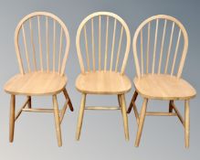 A set of three pine spindle back kitchen chairs.