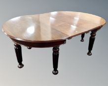 A Victorian mahogany oval dining table with two extension leaves together with a set of eight