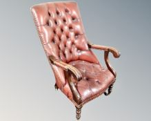 A mahogany framed Chesterfield high backed open armchair upholstered in red buttoned and studded
