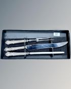 A silver-handled three-piece carving set in Elkington box.
