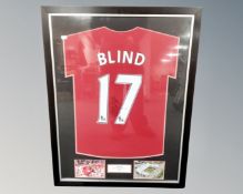 A Daley Blind signed Manchester United shirt with accompanying photographs in mount, framed as one.