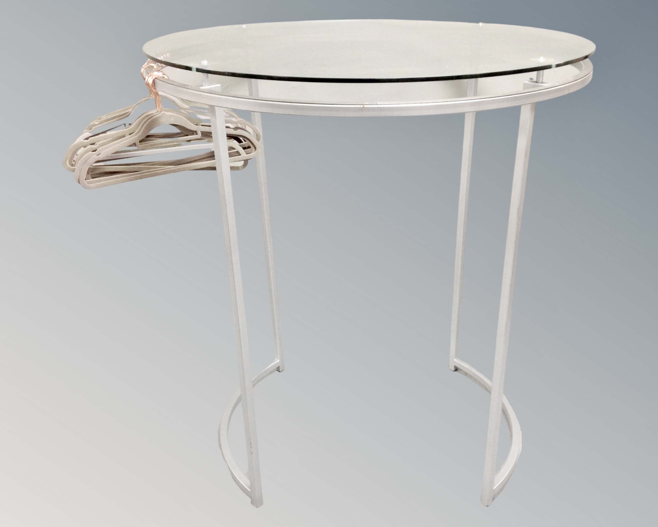 A pair of circular metal glass topped shop display stands / clothes racks with hangers - Image 2 of 2