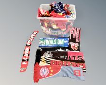 A box containing a large quantity of sports scarves.
