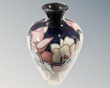 A Moorcroft wild cyclamen bud vase (height 16cm)