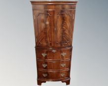 A Regency style mahogany double door cocktail cabinet fitted with cupboard beneath.