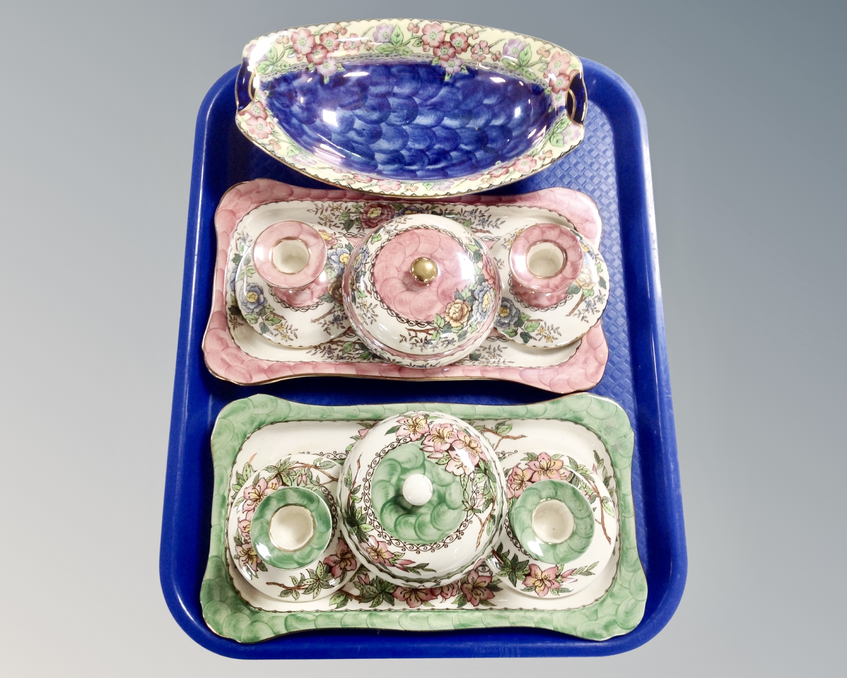 A tray containing Maling lustreware including two dressing table sets and a blue lustre gondola