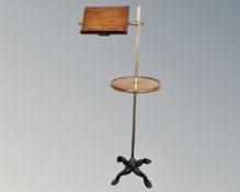 A mahogany and brass music stand on cast iron base.