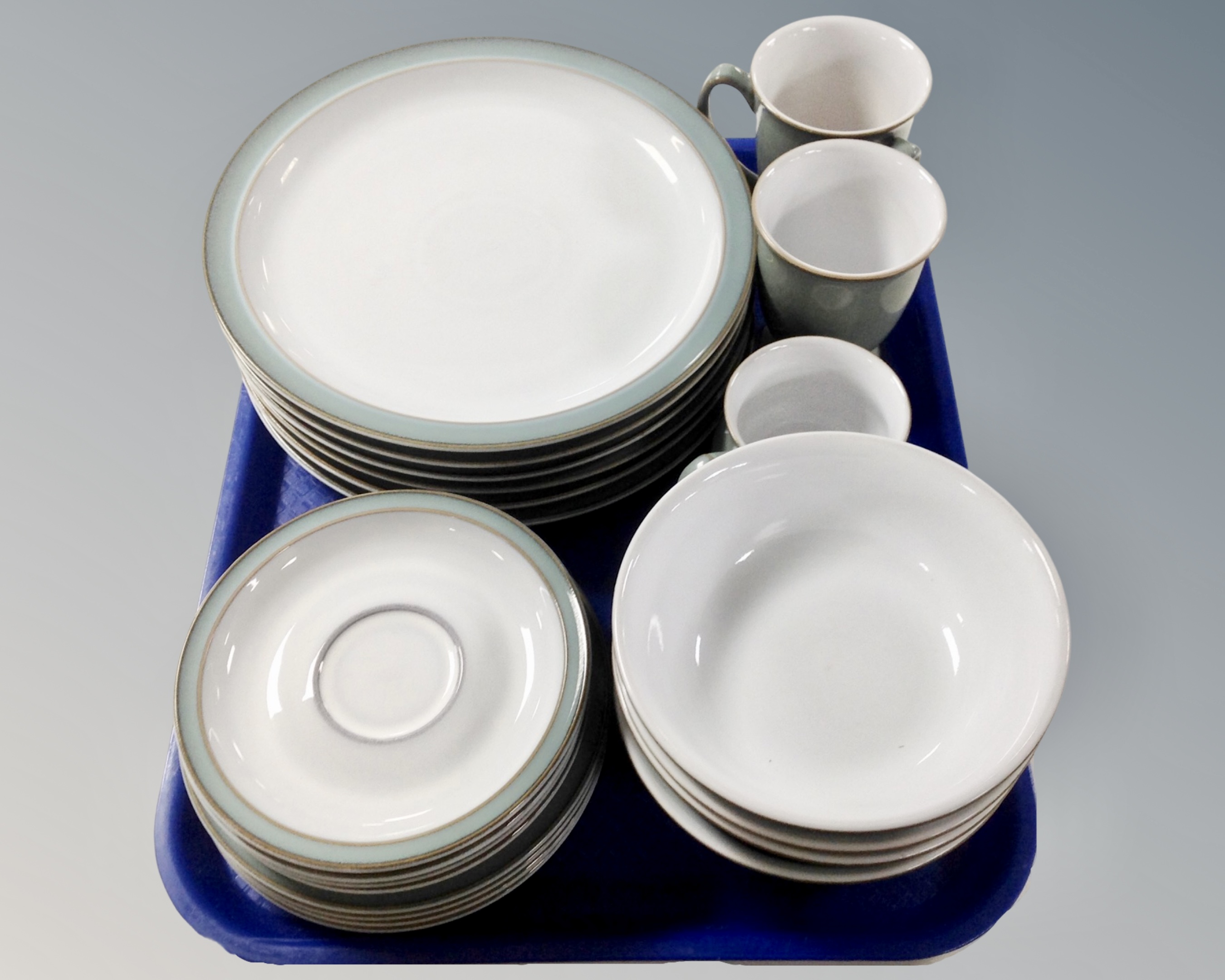 A collection of 21 pieces of Denby pottery dinnerware.