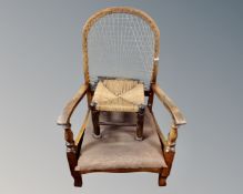 A 20th century beech bergere backed armchair together with a rush seated stool