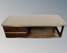 An Ercol stained elm and beech coffee table fitted two drawers and under shelf