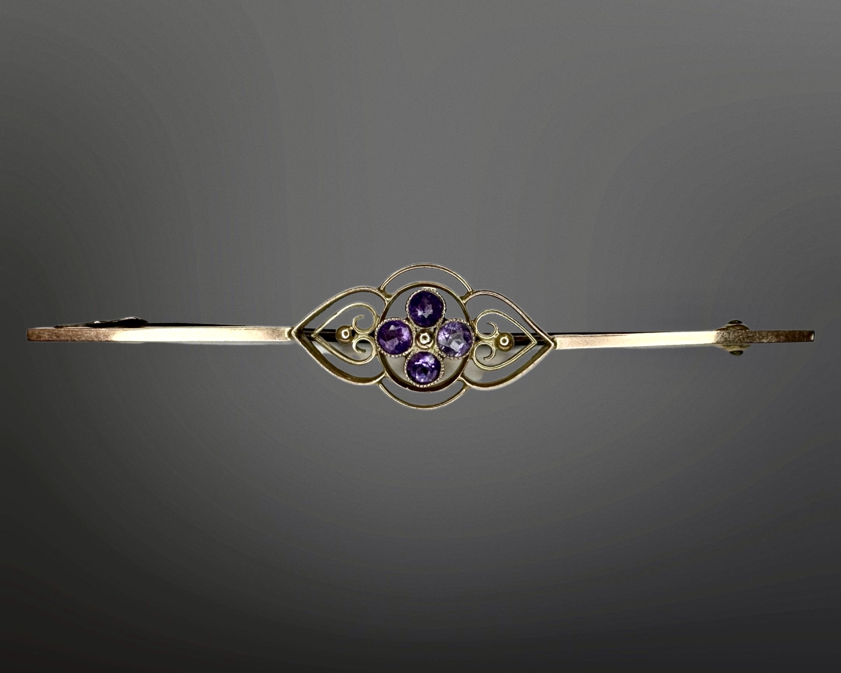 A 9ct gold amethyst bar brooch, length 62mm. CONDITION REPORT: 2.