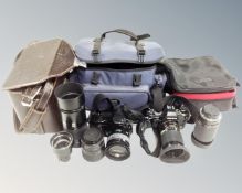 A box containing Minolta Dynax 7XI camera, Yashica FX-103 camera, assorted lenses and camera bags.