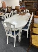 A 20th century painted oak oval extending dining table with three leaves (length 234cm),