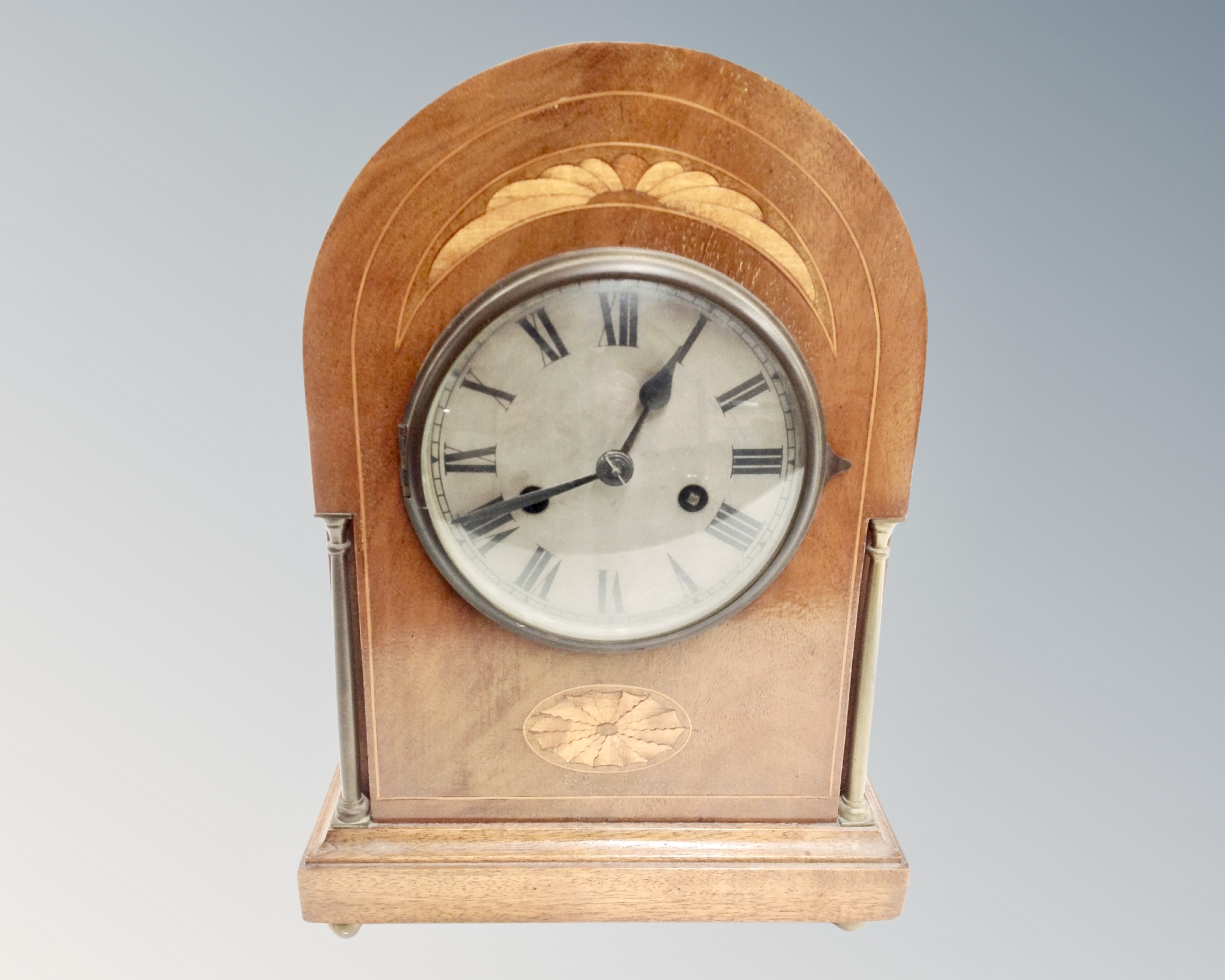 An Edwardian mahogany satinwood inlaid 8 day mantel clock with silvered dial