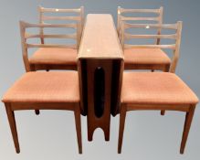 A 1970's teak six piece dining room suite comprising of double door sideboard on raised legs,
