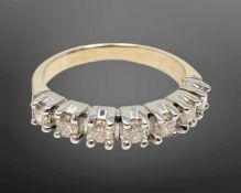 An 18ct gold seven stone diamond half eternity ring, approximately 0.7ct, size P.